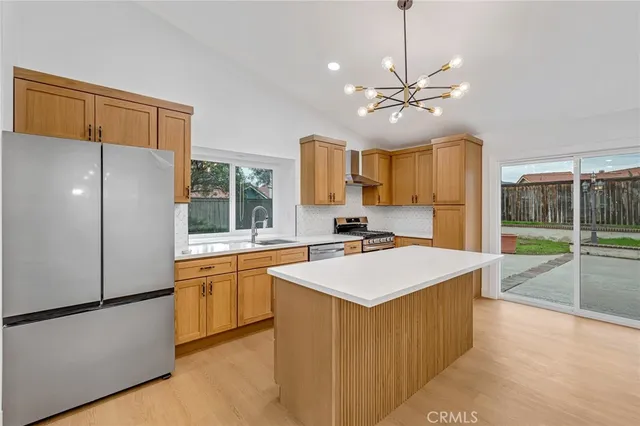 a kitchen with kitchen island a stove a sink and a refrigerator