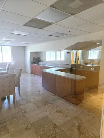a large kitchen with kitchen island a stove a sink dishwasher and cabinets with wooden floor