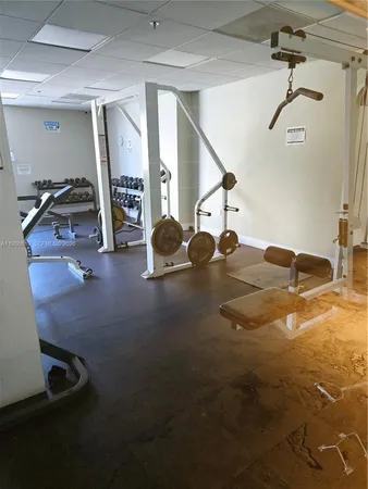 a room with gym equipment and a mirror