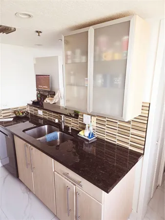 a kitchen with sink and cabinets