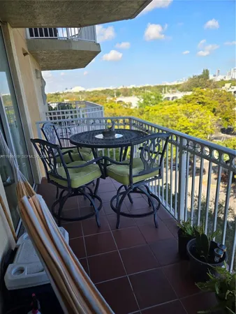 a view of a patio with lawn chairs