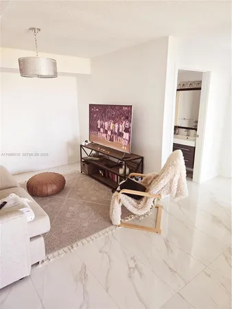 a living room with furniture a rug and a chandelier