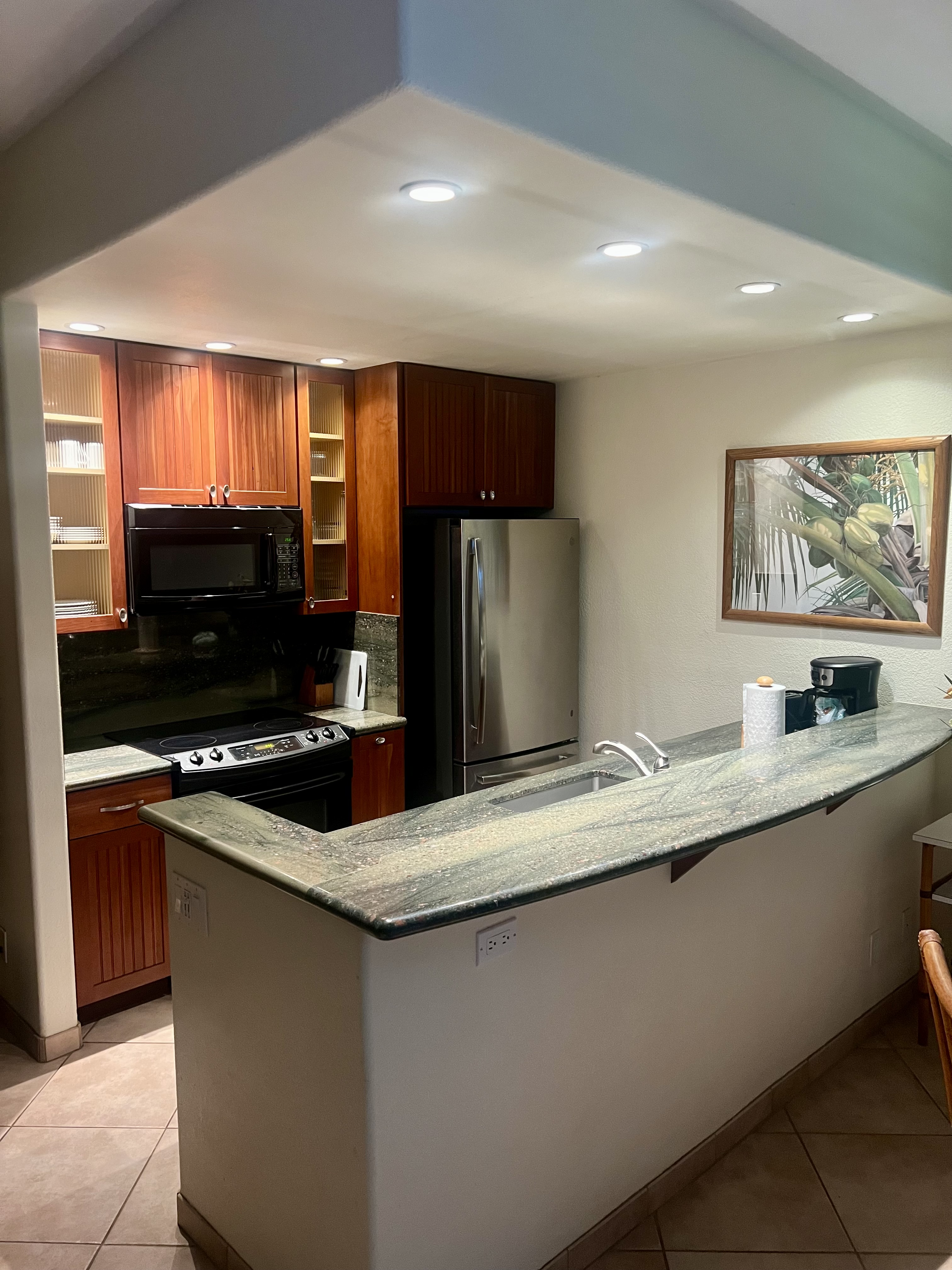2253 Poipu Road, Unit 421 Koloa, HI 96756 - Photo 5 of 11 a kitchen with stainless steel appliances granite countertop a sink and a stove