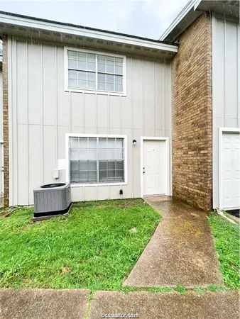a view of front door of house with yard