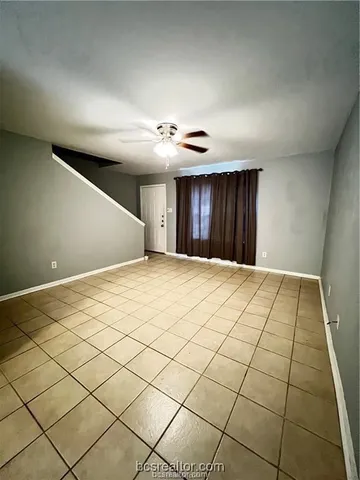 a view of an empty room and a window
