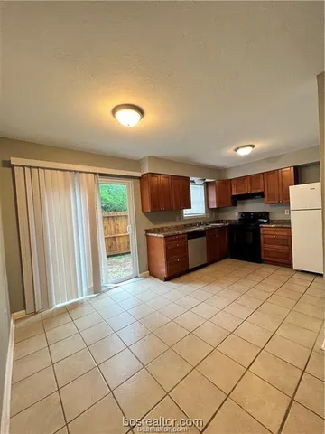 a kitchen with stainless steel appliances a refrigerator and a stove top oven