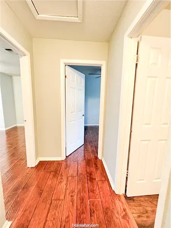 a view of a room with wooden floor and bench