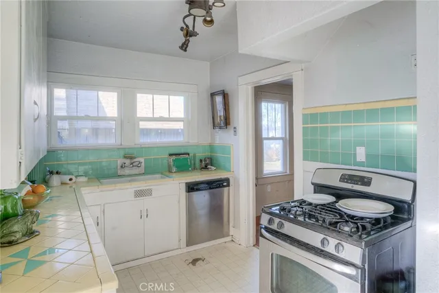 a kitchen with kitchen island a sink stove and cabinets
