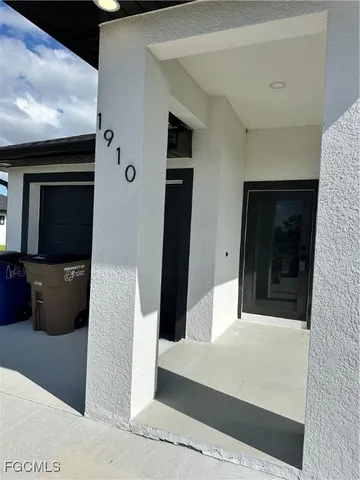a view of a hallway with wooden floor and living room