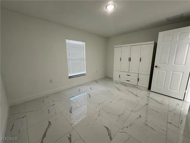 a view of empty room with a fireplace