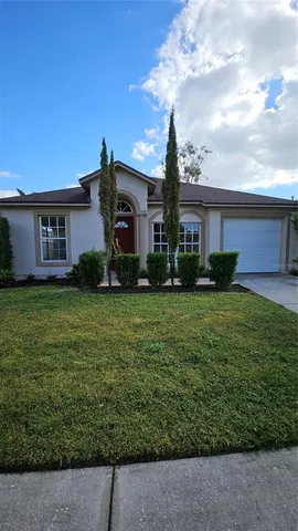 a front view of house with yard and green space
