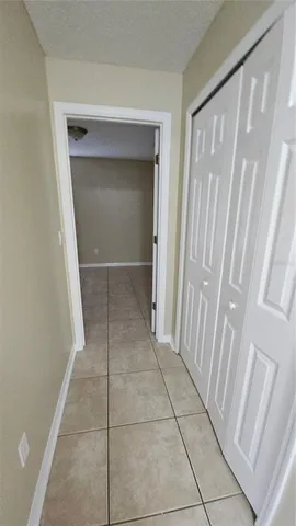an empty room with closet and mirrors