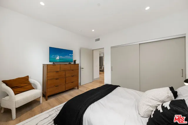 a bedroom with a bed and a couch