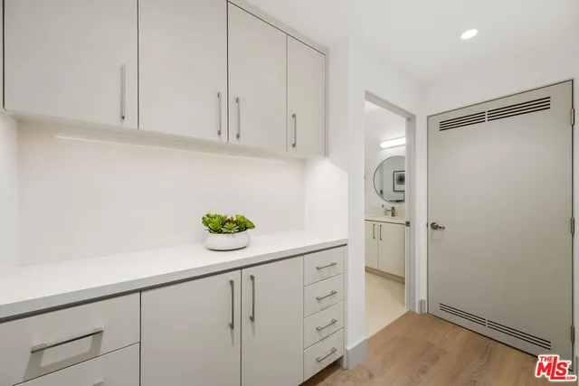 a kitchen with cabinets and a refrigerator