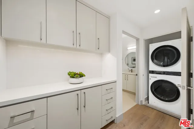 a utility room with sink dryer and washer