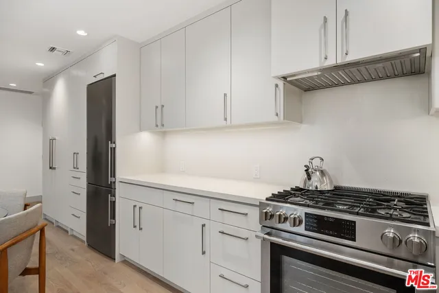 a stove top oven sitting inside of a kitchen
