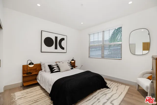 a bedroom with a bed and a lamp