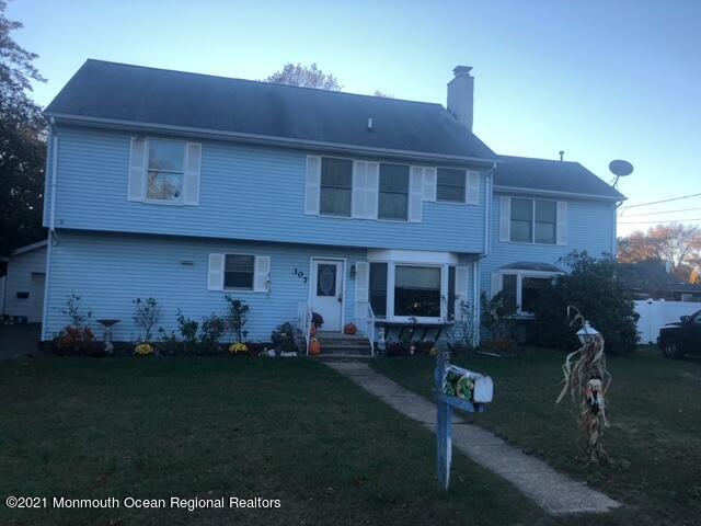 307 Sudbury Road Point Pleasant, NJ 08742 - Photo 1 of 19 a front view of a house with a garden
