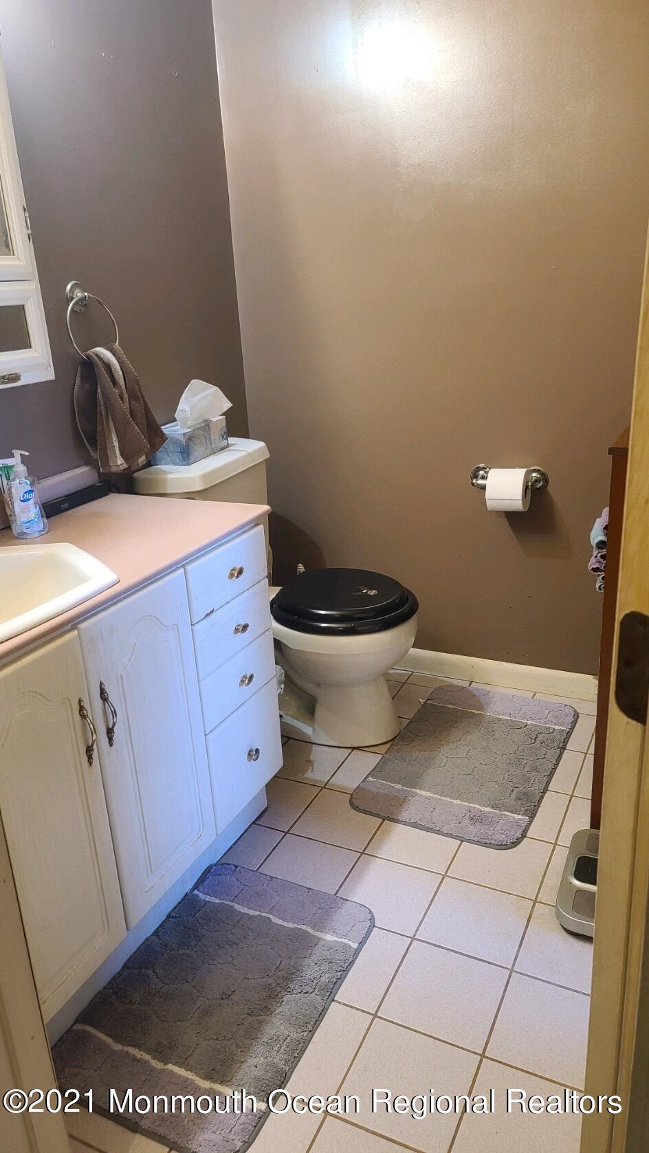 307 Sudbury Road Point Pleasant, NJ 08742 - Photo 17 of 19 a bathroom with a granite countertop toilet and a sink