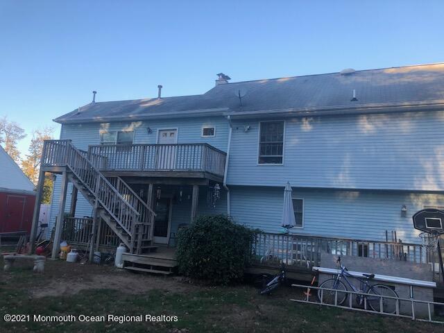 307 Sudbury Road Point Pleasant, NJ 08742 - Photo 18 of 19 a view of a house with wooden deck and furniture