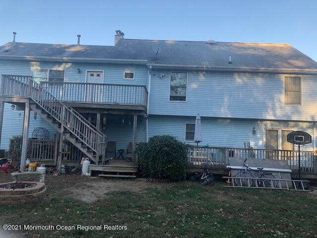 307 Sudbury Road Point Pleasant, NJ 08742 - Photo 19 of 19 a view of a house with a patio and a yard