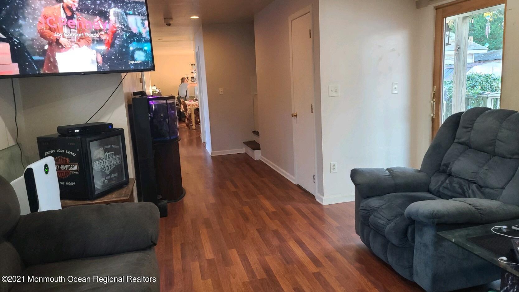 307 Sudbury Road Point Pleasant, NJ 08742 - Photo 2 of 19 a living room with furniture and a flat screen tv