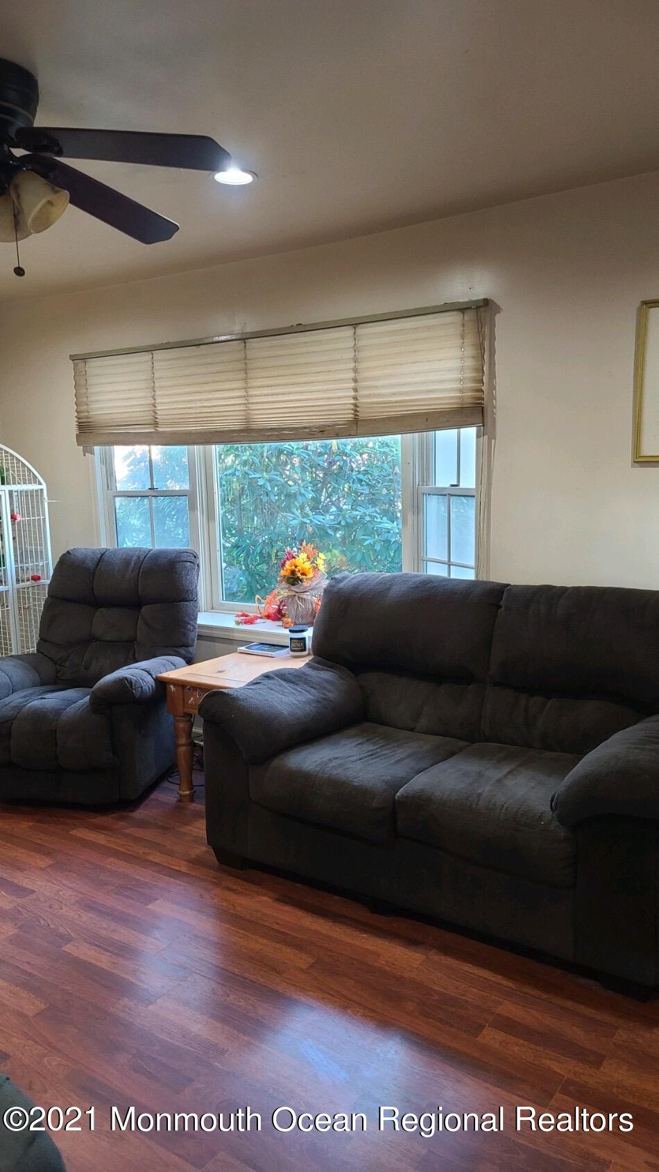 307 Sudbury Road Point Pleasant, NJ 08742 - Photo 4 of 19 a living room with a couch and a large window