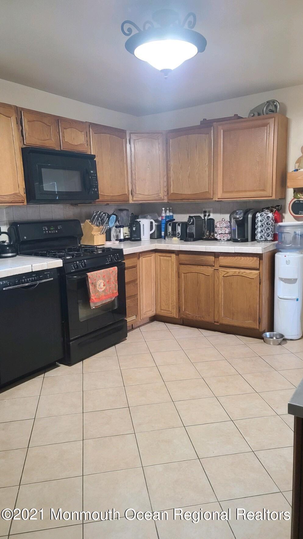 307 Sudbury Road Point Pleasant, NJ 08742 - Photo 6 of 19 a kitchen with stainless steel appliances granite countertop a stove top oven a sink a counter space and cabinets