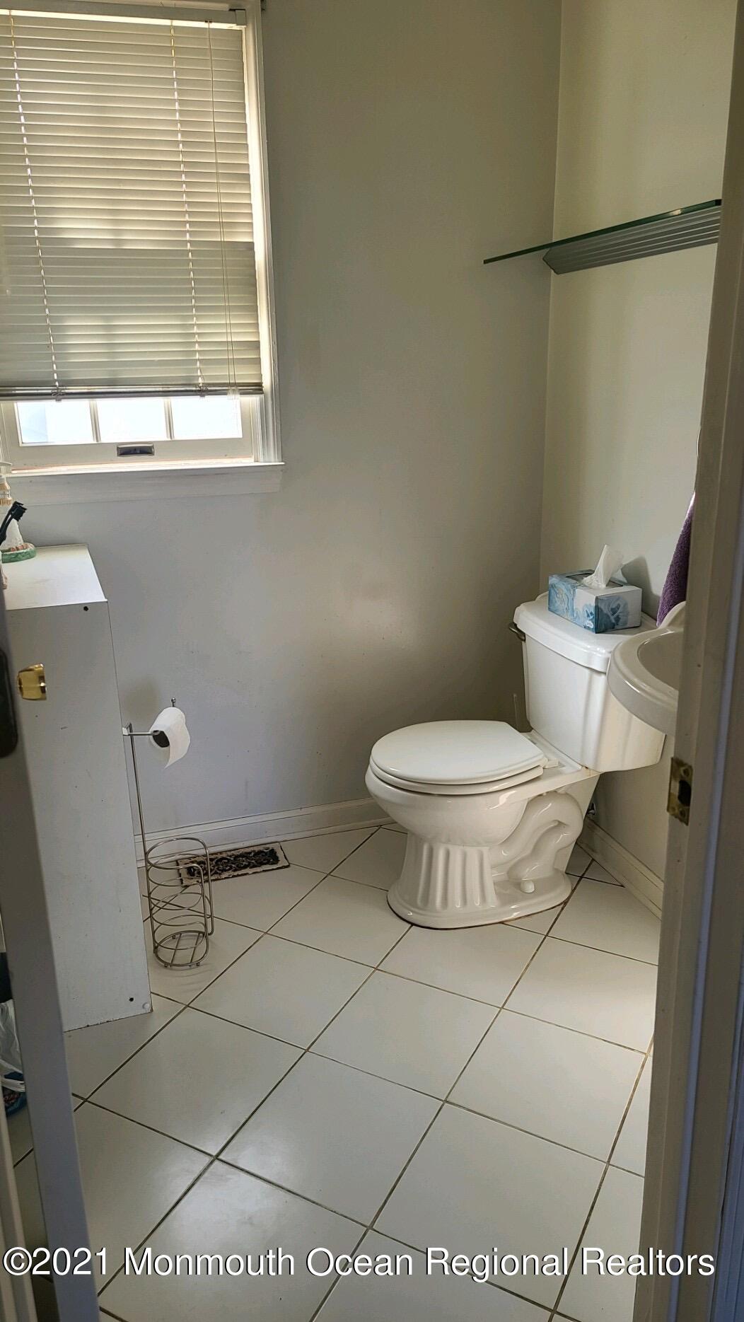 307 Sudbury Road Point Pleasant, NJ 08742 - Photo 7 of 19 a bathroom with a toilet and a window