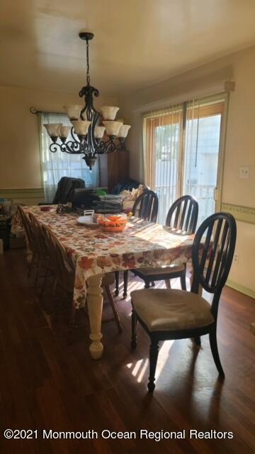 307 Sudbury Road Point Pleasant, NJ 08742 - Photo 8 of 19 a dining room with a table chairs and a chandelier