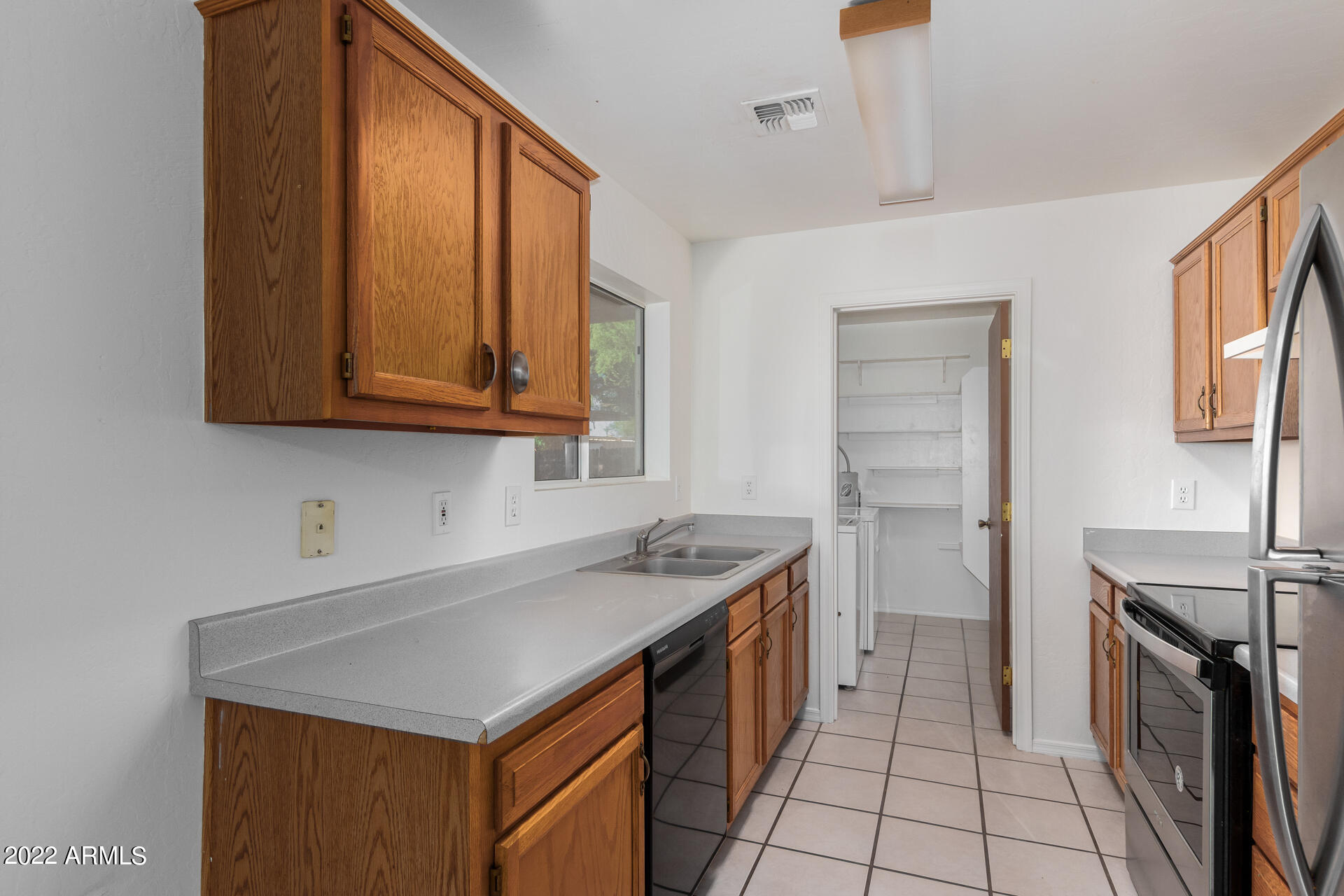 118 North Signal Butte Road Apache Junction, AZ 85120 - Photo 8 of 21 a kitchen with stainless steel appliances granite countertop a sink stove and cabinets