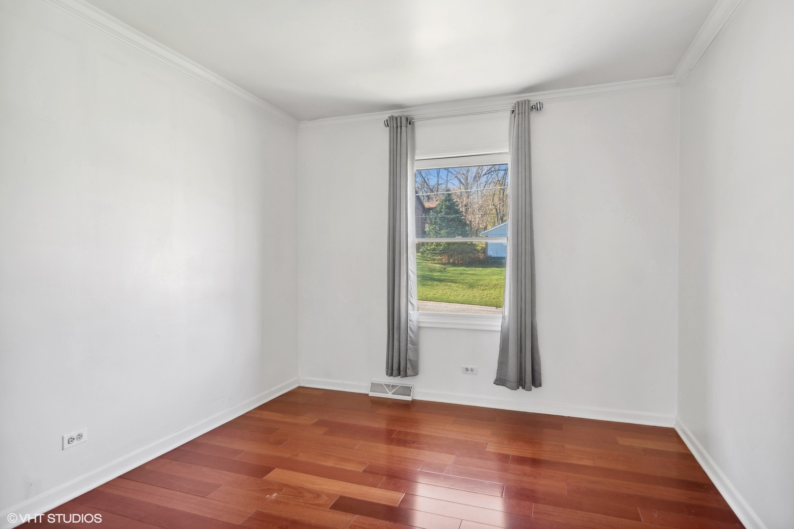 245 Thomas Street Cary, IL 60013 - Photo 14 of 28 an empty room with wooden floor and a window