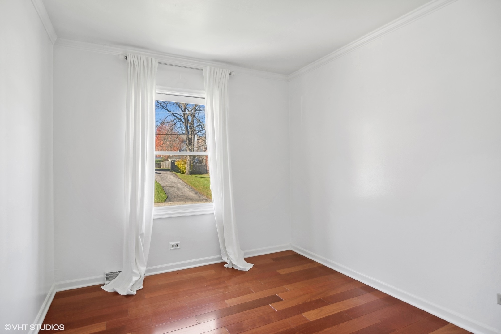 245 Thomas Street Cary, IL 60013 - Photo 15 of 28 a view of an empty room with wooden floor and a window