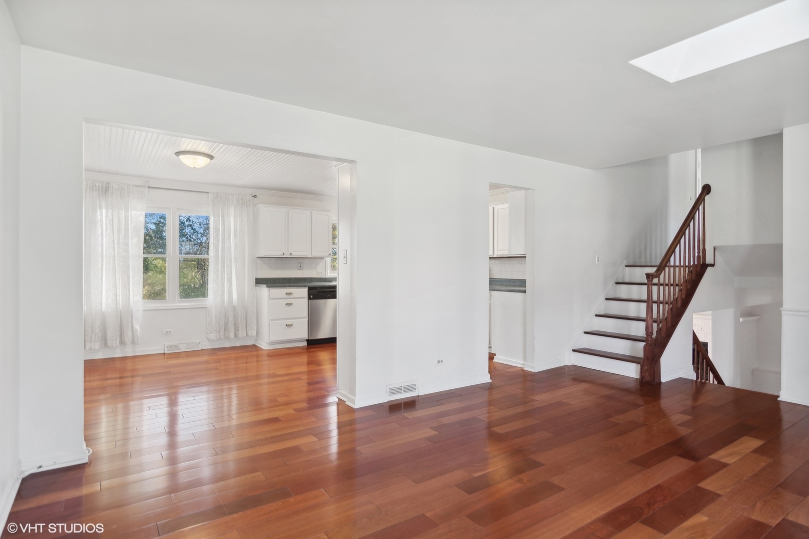 245 Thomas Street Cary, IL 60013 - Photo 4 of 28 a view of empty room with wooden floor and kitchen