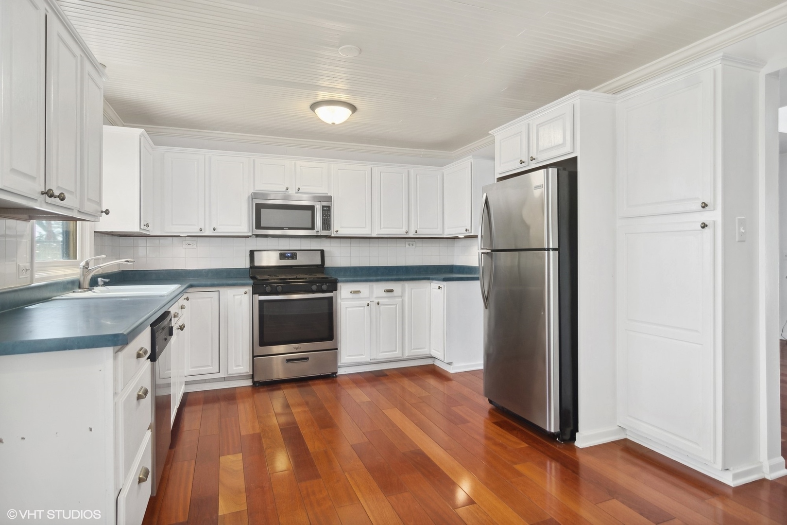 245 Thomas Street Cary, IL 60013 - Photo 5 of 28 a kitchen with a refrigerator stove and white cabinets