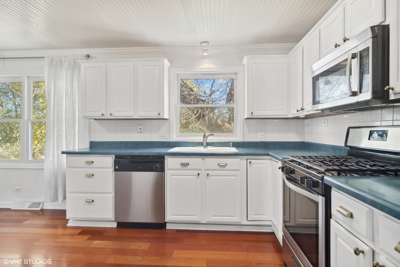 245 Thomas Street Cary, IL 60013 - Photo 6 of 28 a kitchen with stainless steel appliances granite countertop a stove a sink and a microwave