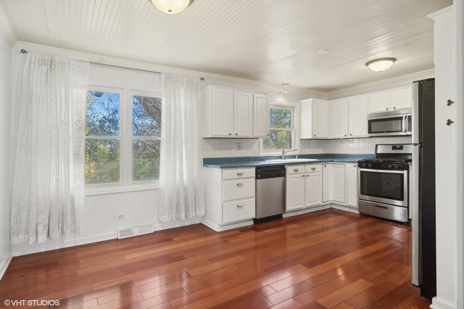 245 Thomas Street Cary, IL 60013 - Photo 8 of 28 a kitchen with granite countertop white cabinets and white appliances