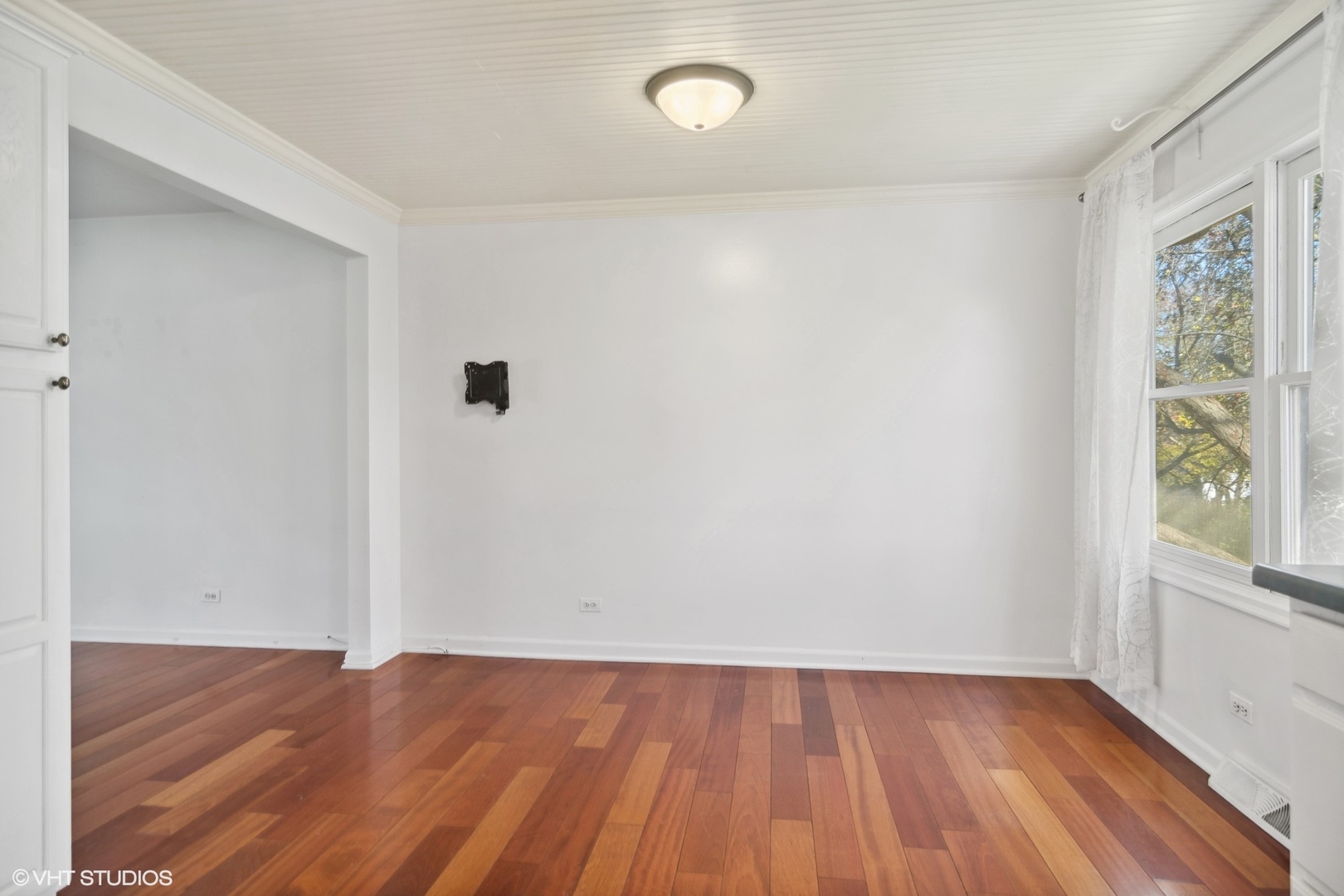 245 Thomas Street Cary, IL 60013 - Photo 9 of 28 an empty room with wooden floor and windows