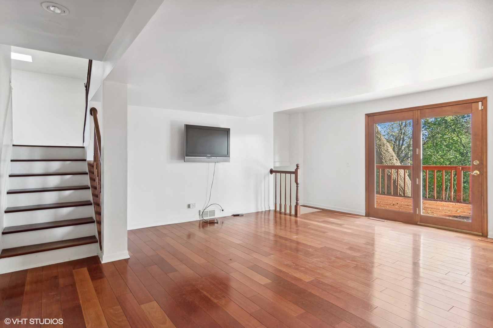 245 Thomas Street Cary, IL 60013 - Photo 10 of 28 a view of an empty room with wooden floor and a window