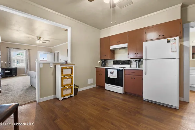 a view of a livingroom with furniture and hardwood floor