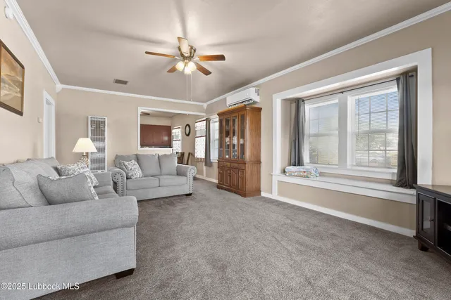 a living room with furniture and a kitchen