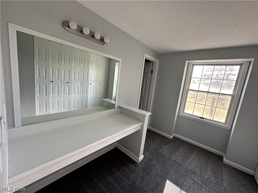 16213 Drake Road Strongsville, OH 44136 - Photo 13 of 28 Unfurnished bedroom with a closet, a textured ceiling, and dark colored carpet