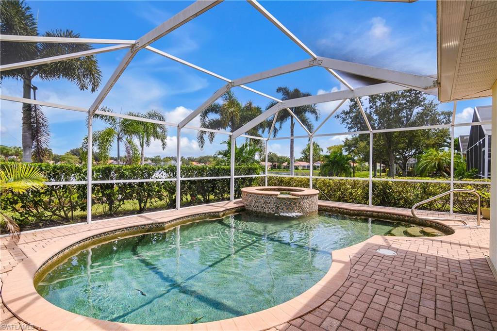 19633 Villa Rosa Loop Estero, FL 33967 - Photo 1 of 50 View of pool featuring glass enclosure and a patio