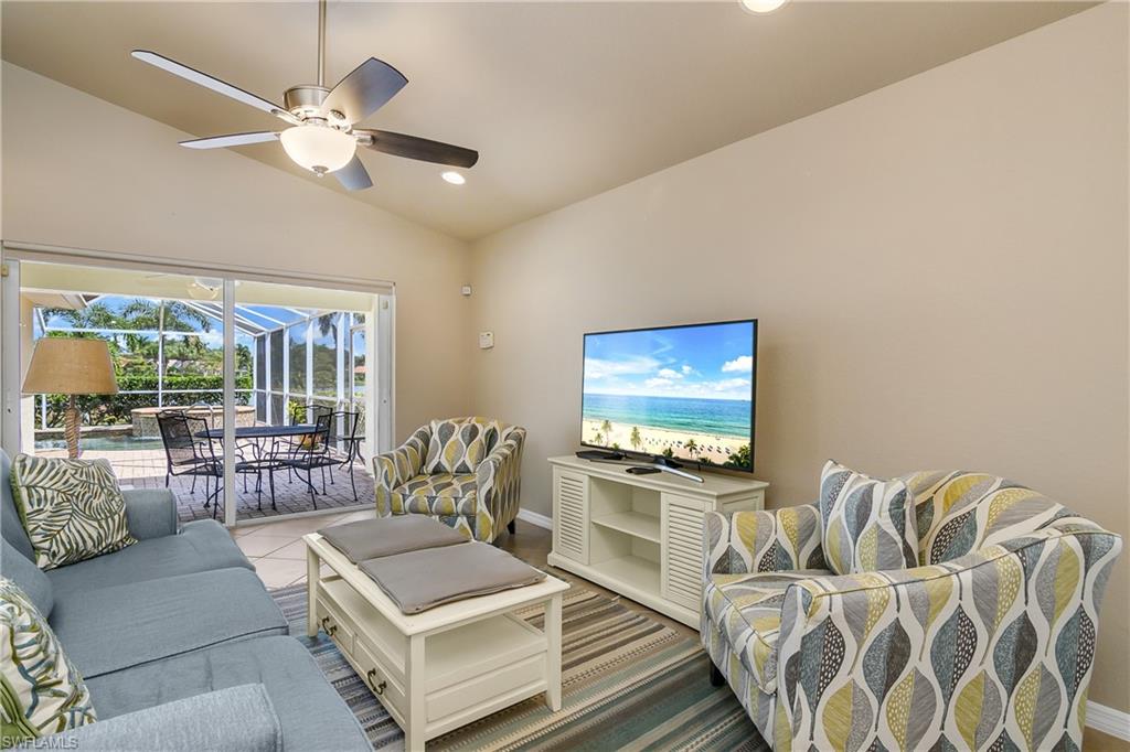 19633 Villa Rosa Loop Estero, FL 33967 - Photo 14 of 50 Living room with lofted ceiling, ceiling fan, and tile patterned floors