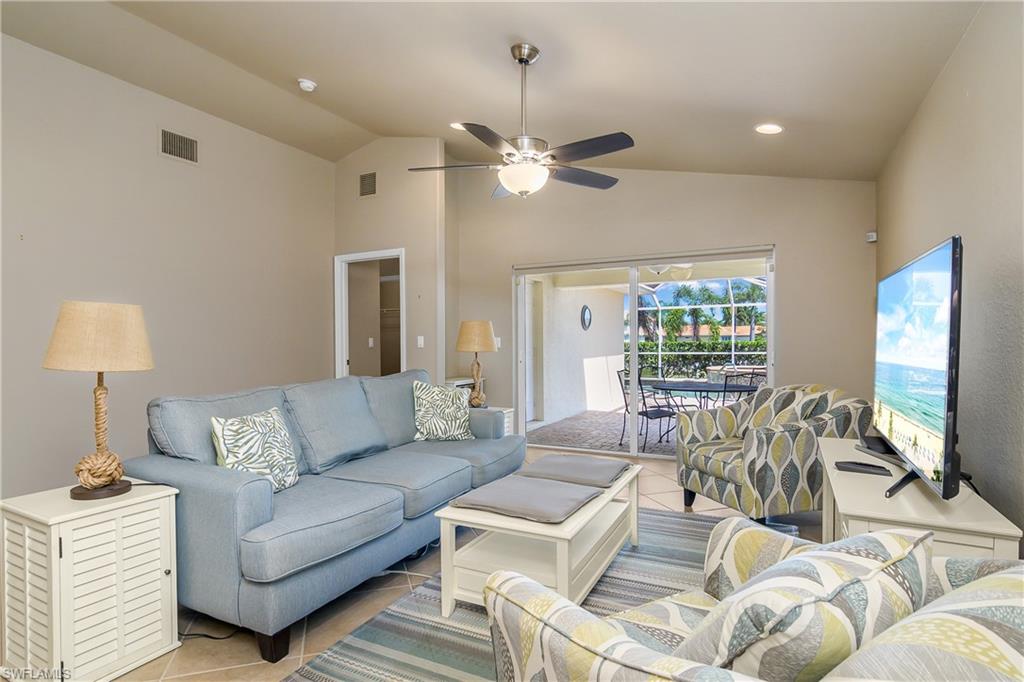 19633 Villa Rosa Loop Estero, FL 33967 - Photo 15 of 50 Tiled living room with lofted ceiling and ceiling fan