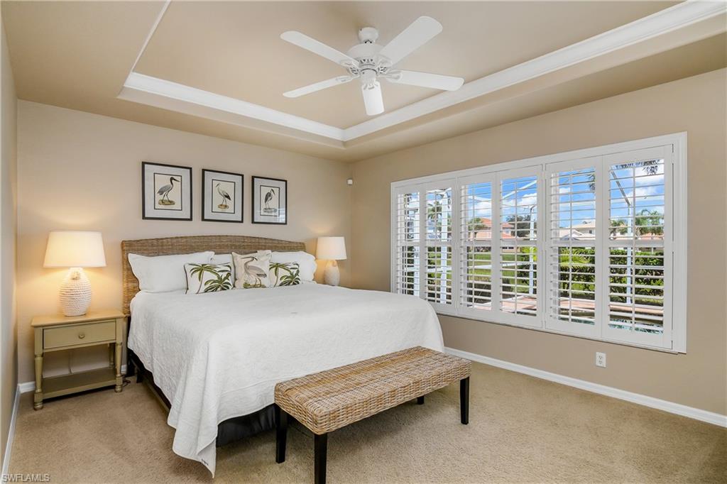 19633 Villa Rosa Loop Estero, FL 33967 - Photo 18 of 50 Carpeted bedroom featuring a tray ceiling and ceiling fan