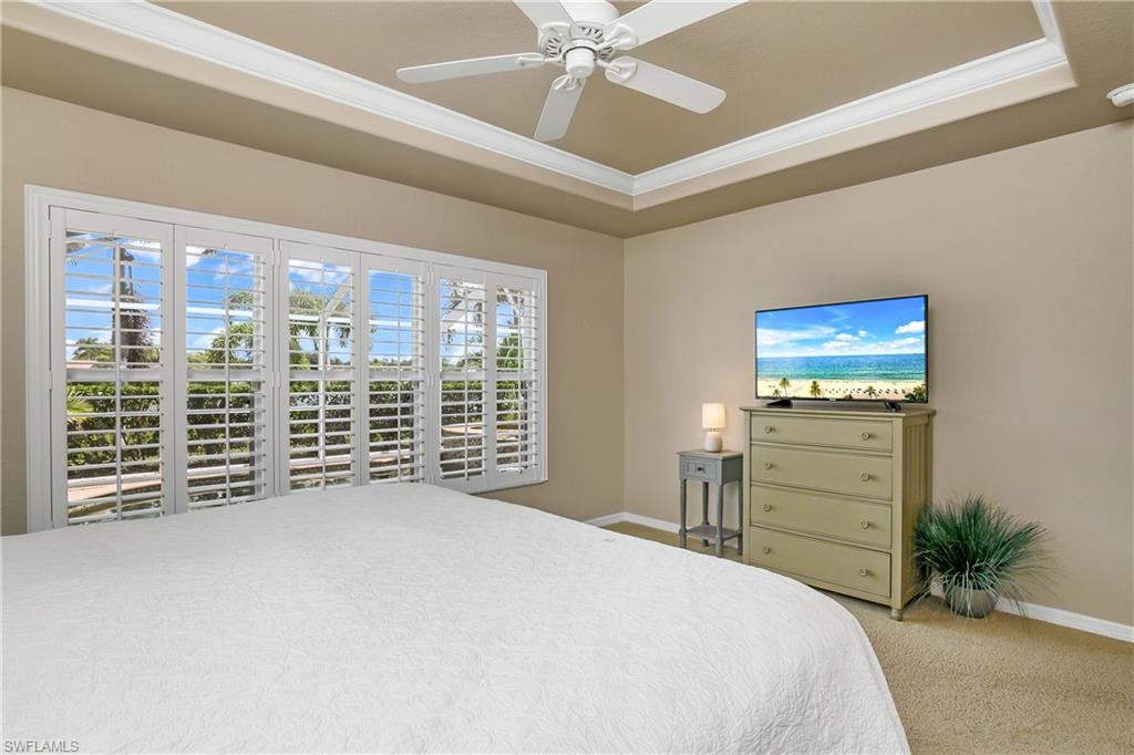 19633 Villa Rosa Loop Estero, FL 33967 - Photo 19 of 50 Carpeted bedroom featuring crown molding, a raised ceiling, and ceiling fan