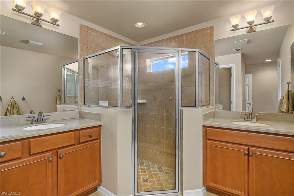19633 Villa Rosa Loop Estero, FL 33967 - Photo 20 of 50 Bathroom featuring a shower with door and vanity