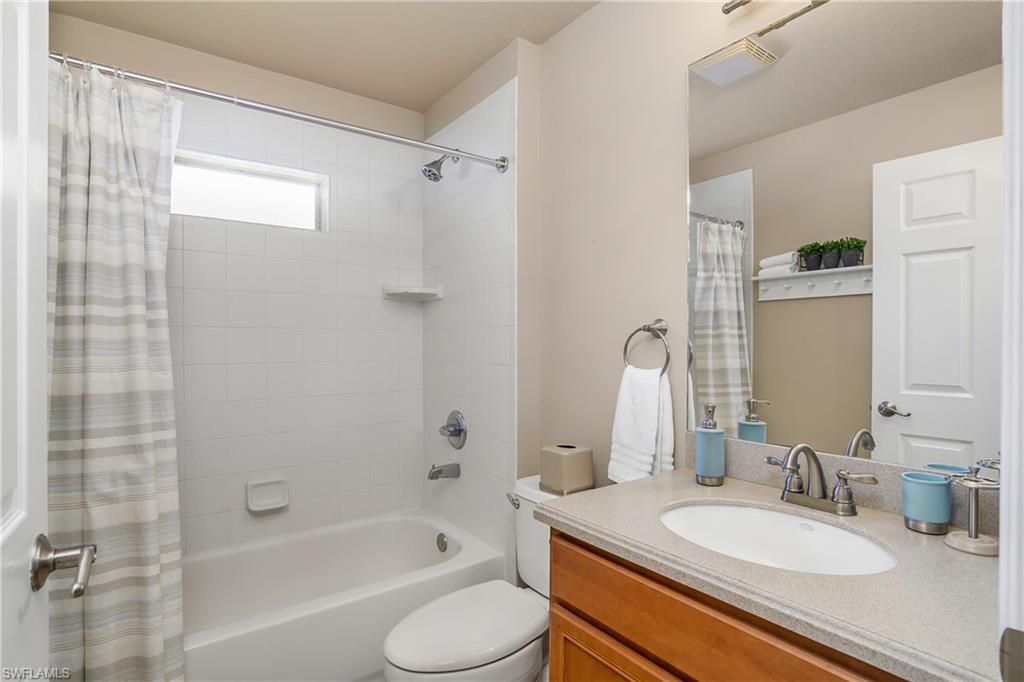19633 Villa Rosa Loop Estero, FL 33967 - Photo 23 of 50 Full bathroom featuring vanity, toilet, and shower / bath combination with curtain