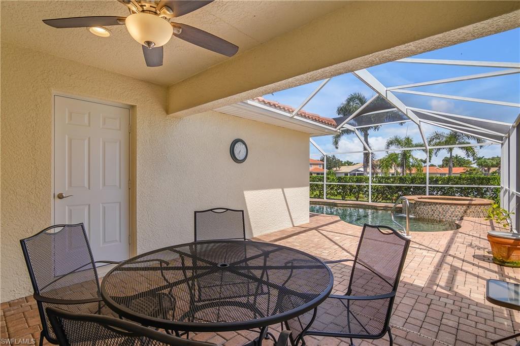 19633 Villa Rosa Loop Estero, FL 33967 - Photo 28 of 50 View of patio / terrace featuring ceiling fan, glass enclosure, and a swimming pool with hot tub